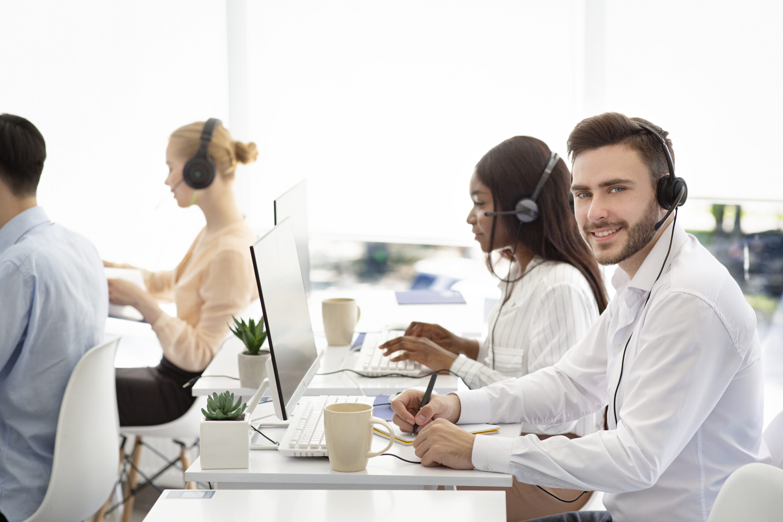 Diverse customer service operators helping clients, resolving technical issues or selling goods at call centre Diverse customer service operators helping clients, resolving technical issues or selling goods at call centre. Positive tech support agents working in telecommunications or telemarketing